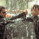 Neo and Agent Smith fighting in the rain.